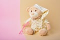 Cute teddy bear and pink baby glasses on beige and pink background