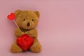 Cute teddy bear with red heart and gift box on pink background, space for text. Valentine`s day celebration Royalty Free Stock Photo