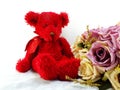 Cute teddy bear with red heart and tulip artificial flowers
