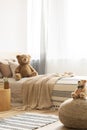 Teddy bear on single bed in bright kid`s room Royalty Free Stock Photo