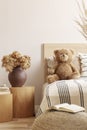 Teddy bear on single bed in natural kid`s room Royalty Free Stock Photo