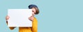 Young boy peeking out from behind white notice board Royalty Free Stock Photo