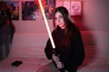Cute teen cosplay girl gamer movie fan with light sword Royalty Free Stock Photo