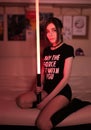 Cute teen cosplay girl gamer movie fan with light sword