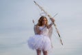 Cute teen cupid on the cloud - sky background. Lovely and cute youth. Lovely girl cupid with bow and arrow is ready to Royalty Free Stock Photo