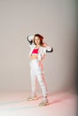 Cute teen dancing hip hop in reflective pants, in Studio with neon lighting. Dance color poster Royalty Free Stock Photo