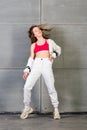 Cute teen dancing hip hop in reflective pants, in Studio with neon lighting. Dance color poster Royalty Free Stock Photo