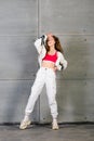 Cute teen dancing hip hop in reflective pants, in Studio with neon lighting. Dance color poster Royalty Free Stock Photo