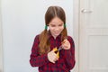 Teen girl cutting hair to herself with scissors Royalty Free Stock Photo