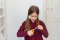 Teen girl cutting hair to herself with scissors Royalty Free Stock Photo