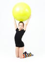 Cute teen girl doing gymnastics exercises with fitness ball Royalty Free Stock Photo