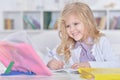 Close up portrait of cute teen girl doing homework in her room Royalty Free Stock Photo