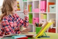 Cute teen girl doing homework in her room Royalty Free Stock Photo