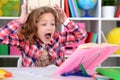 Cute teen girl doing homework in her room Royalty Free Stock Photo