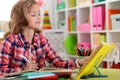 Cute teen girl doing homework in her room Royalty Free Stock Photo