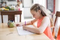 Cute teen girl doing homework at home Royalty Free Stock Photo