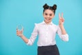 Cute teen girl drinking water from glass on blue background. Daily life health. Drink water for health care and body Royalty Free Stock Photo