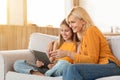 Cute teen girl having fun at home with her grandmother Royalty Free Stock Photo