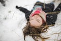 Cute teen girl having fun on a walk in snow covered pine forest on chilly winter day. Teenage child exploring nature Royalty Free Stock Photo