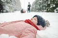 Cute teen girl having fun on a walk in snow covered pine forest on chilly winter day. Teenage child exploring nature Royalty Free Stock Photo