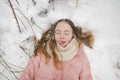 Cute teen girl having fun on a walk in snow covered pine forest on chilly winter day. Teenage child exploring nature Royalty Free Stock Photo