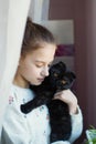 Cute teen girl holding a little kitten in her arms Royalty Free Stock Photo