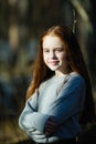 Cute teen girl with long bright red hair closeup portrait