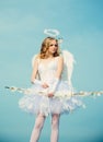 Cute teen girl. Love card. Arrow of love. Cupid in valentine day. Pretty white little girl as the cupid with a bow and Royalty Free Stock Photo