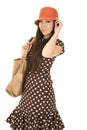 Cute teen girl model wearing a polka dot dress and orange hat Royalty Free Stock Photo