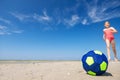 Cute teen girl playing and having fun with ball on beach at sunny summer day Royalty Free Stock Photo