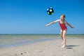 Cute teen girl playing and having fun with ball on beach at sunny summer day Royalty Free Stock Photo