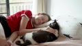 Cute teen girl playing with her cat and fall asleep on bed