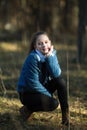 Cute fun teen girl is posing in a pine Park