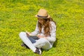 Cute teen girl reading a book on a green meadow. Selective focus Royalty Free Stock Photo
