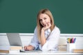 Cute teen girl, school student write notes, watch video online webinar, learn on laptop, sit in classroom, distance Royalty Free Stock Photo