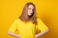 Cute teen girl. Studio image of a cute smiling young girl on yellow background