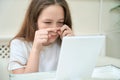 Cute teen girl trying to squeeze pimple on her nose Royalty Free Stock Photo