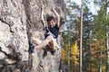 Cute teen kid climbing on rock with insurance, lifestyle sport people concept Royalty Free Stock Photo