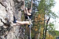 Cute teen kid climbing on rock with insurance, lifestyle sport people concept Royalty Free Stock Photo