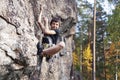 Cute teen kid climbing on rock with insurance, lifestyle sport people concept Royalty Free Stock Photo