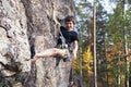 Cute teen kid climbing on rock with insurance, lifestyle sport people concept Royalty Free Stock Photo