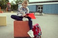 Cute teen school girl sitting and learning before lessons  at school yard Royalty Free Stock Photo
