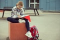 Cute teen schoolgirl writing with pen in school yard Royalty Free Stock Photo