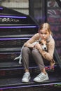 Cute teenage blonde girl with dog on the steps.
