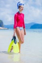 Teenage girl in bikini carrying scubadiving equipment