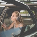Cute teenage girl listening to her favorite music/audiobook on hig-end headphones