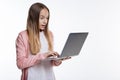 Cute teenage girl looking surprised while reading email Royalty Free Stock Photo