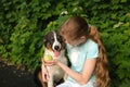 teenage girl play with australian shepherd puppy dog in summer. in forest Royalty Free Stock Photo