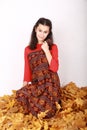 Teen girl on dried leaves in traditional Indonesian dress Royalty Free Stock Photo