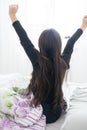 Cute teenage girl stretching on the bed in her room having fun. Royalty Free Stock Photo